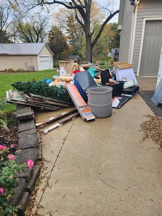 Dumpster being loaded with debris for 3 Yard Dumpster Rental in Drum Point